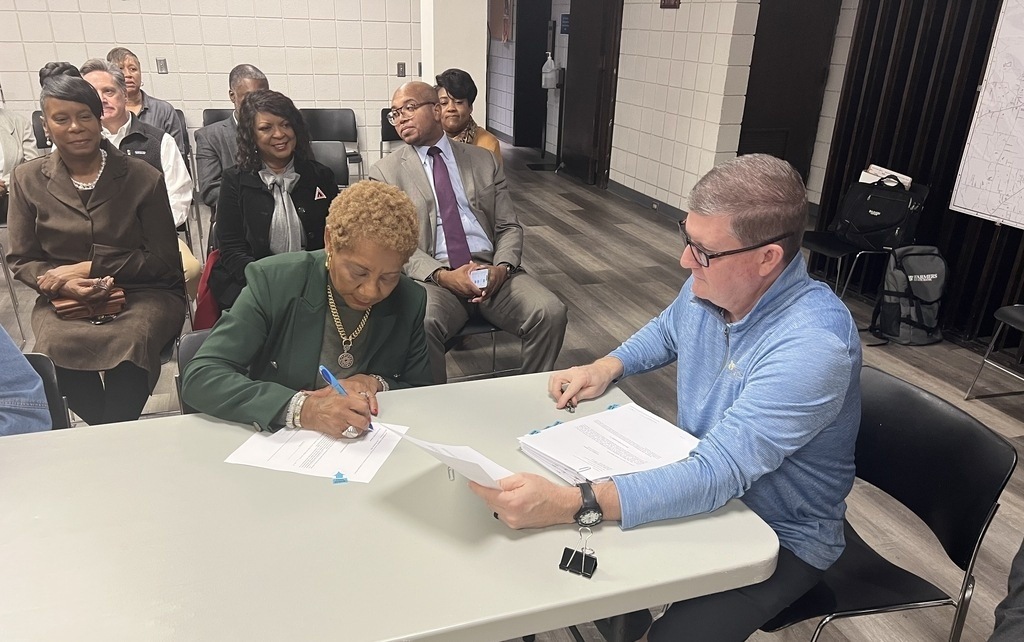 Pine Bluff City Officials sign closing paperwork for a new Courtyard by Marriott hotel